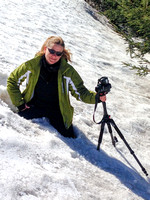 Portrait of Hobit Lafaye climbing through a snow bank with her camera
